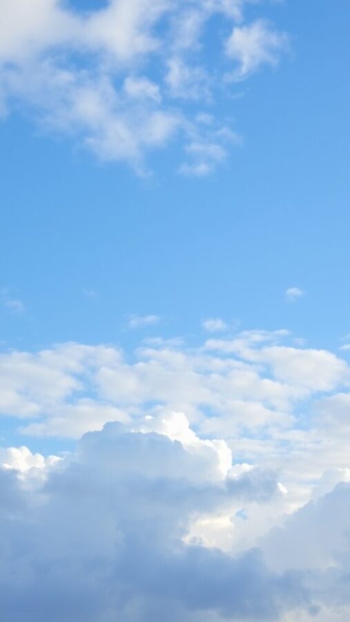 50 Stunning Aesthetic Wallpapers for Your iPhone 26 A serene blue sky filled with soft, fluffy clouds