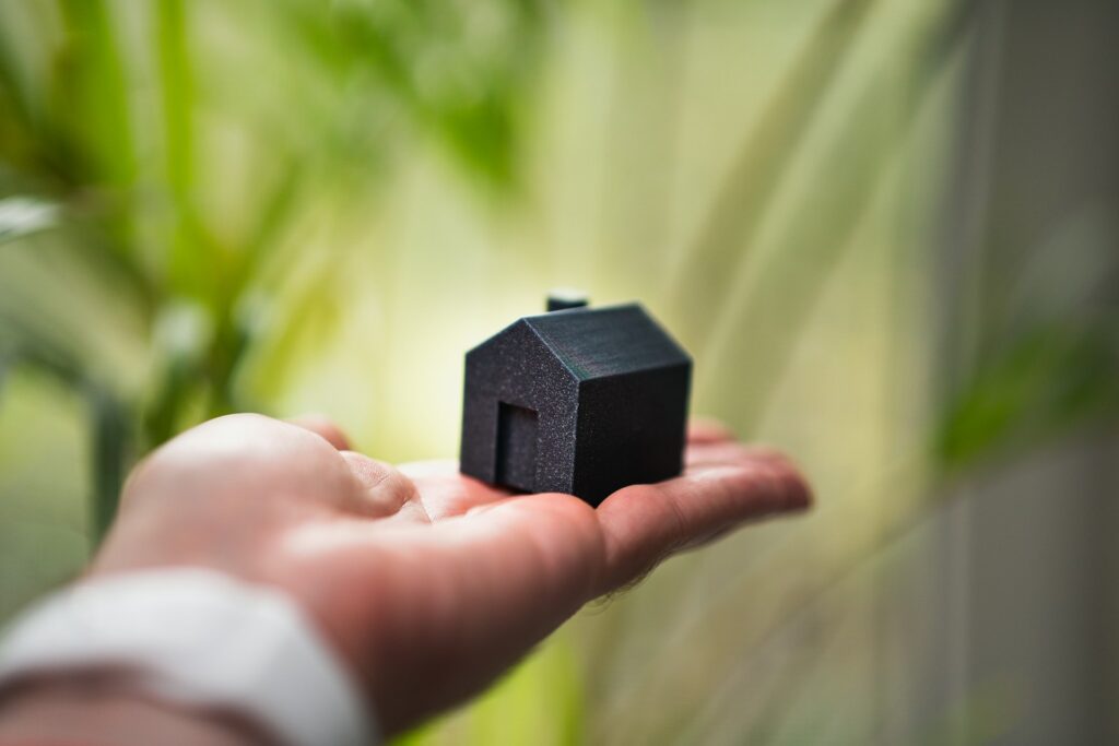 6 Ways to Insure Your Home Office Furniture 1 A person holding a small house in their hand