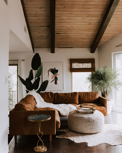 earthy living room with brown sectional and light color palette