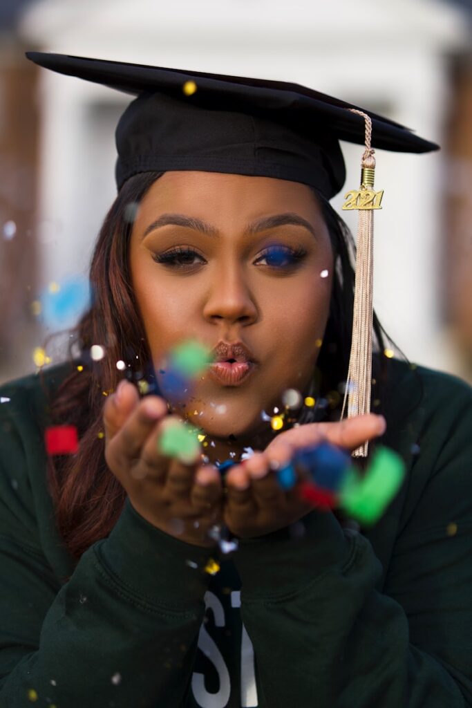 The 10 Best Online MBA Programs in 2025 1 a woman in a graduation cap blowing bubbles